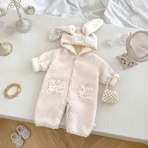 Detail of baby floral bunny ear romper featuring plush lamb wool and cute floral patterns