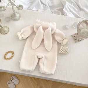 Detailed view of plush rabbit ear hood and floral lining on warm winter baby romper