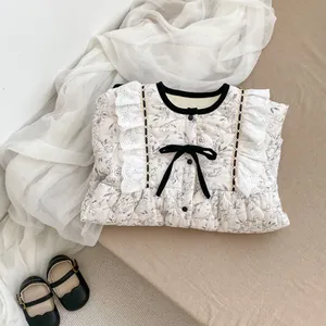 Macro detail of floral baby winter romper with quilted texture and lace trim edges