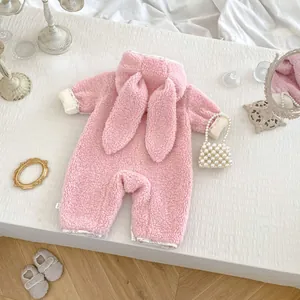 Detailed view of pink fuzzy baby romper featuring cute long bunny ears and floral lining