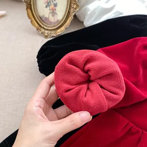 Close-up of thick red velvet fabric with soft fleece lining for warm winter dress