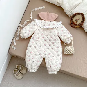 Detailed view of floral quilted baby romper with lace collar and ribbed cuffs