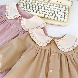 Detail of vintage baby blouses with oversized ruffle Peter Pan collar and pleated cotton fabric