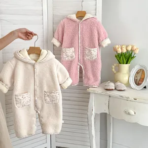 Detail of baby floral hooded romper with warm lamb wool texture and cute pockets