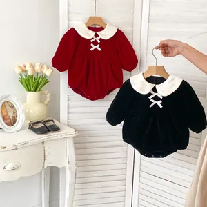 Detail of velvet baby bodysuit with Peter Pan collar and bow ties for Lunar New Year