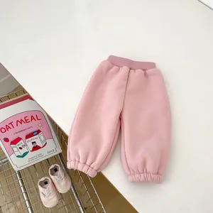 Close-up of pink winter pants for baby girls with elastic waist and ribbed cuffs