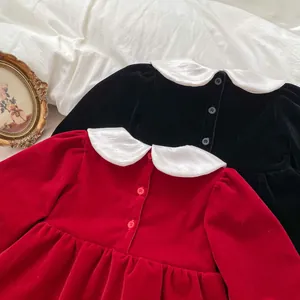 Close-up of velvet girl dresses showing Peter Pan collar and back button details