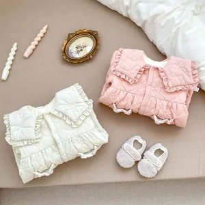 Detailed quilted texture and delicate floral embroidery on baby winter rompers