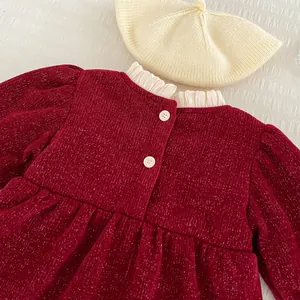Detail von rotem Glitzer-Cord-Babykleid mit weißem Rüschenkragen und Perlenknöpfen