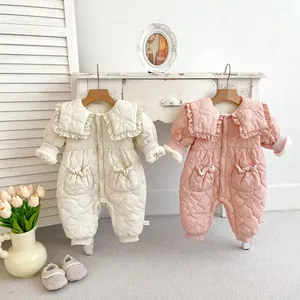 Detail of quilted floral embroidery and ruffled collar on thick baby rompers