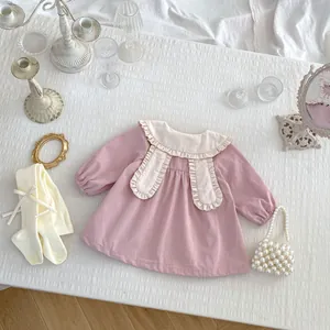 Detail of pink toddler girl dress with white ruffled bunny ear collar and lace edge