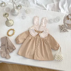 Detail of khaki toddler dress featuring cute rabbit ear collar and vintage lace ruffles