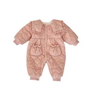 Pink quilted infant romper with floral embroidery and ruffled collar on white background