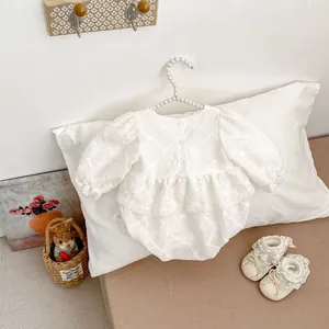 Detailed embroidery and lace trim on sweet long-sleeve baby romper with matching shoes