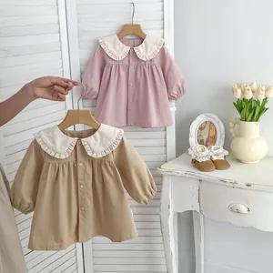 Detailed view of baby girl cotton cardigans with large ruffle collars and wood buttons