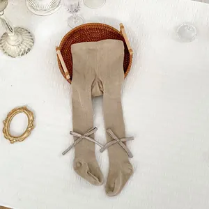 Spring knit baby footed tights in beige with cute satin bows on the ankles
