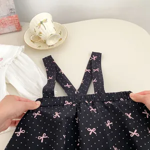 Détail de la taille élastique et du motif nœud rose sur la jupe noire pour bébé