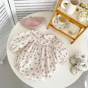 Detailed view of floral long-sleeve baby romper with Peter Pan collar and matching bonnet