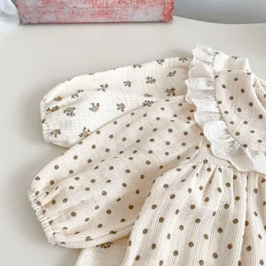 Close-up of floral polka dot baby romper featuring hollow lace collar and waffle texture