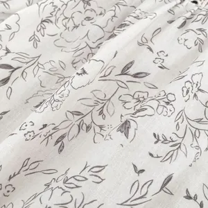Baby floral bodysuit closeup featuring elegant flower prints on breathable cotton linen