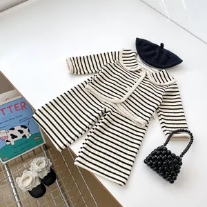 Détail de l'ensemble tricoté rayé pour tout-petit avec cardigan et accessoires chic