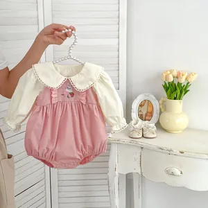 Close-up of baby girl romper set featuring lace collar and cute bunny embroidery