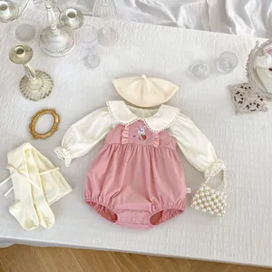 Detail of pink baby romper with rabbit embroidery and delicate lace collar shirt