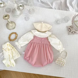 Detailed flat lay of baby girl pink romper set with lace collar shirt and pearl mini bag