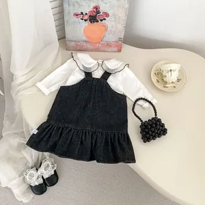 Detailansicht von Jeans-Trägerkleid für Mädchen und weißem Hemd mit großem Rüschenkragen