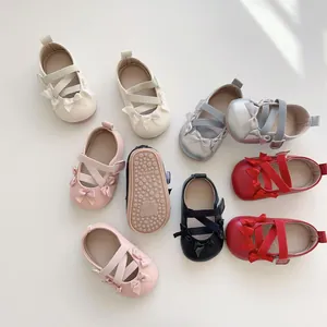 Dettaglio delle suole antiscivolo e dei fiocchi sulle scarpe Mary Jane per neonati