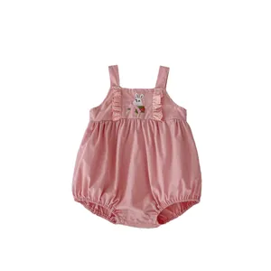Pink infant overall with bunny embroidery and ruffle detail on clean white background