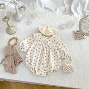 Detailed flat lay of floral baby romper with lace collar, beret, and ribbed tights