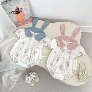 Detail of infant rompers with rabbit ear collars and cute bear prints in pink and blue