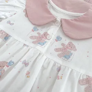 Detail of baby summer romper with pink polka dots and cute bear print pattern