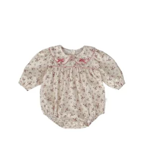Sweet floral baby girl bodysuit with long sleeves and pink bow collar on white background