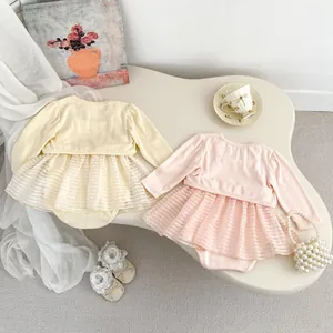 Flat lay detail of cute baby girl summer rompers with mesh skirts and long sleeve cardigans