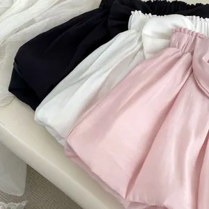 Close-up of girls' breathable cotton shorts with elastic ruffled waist in pink, white and black
