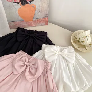 Close-up of baby girls' bloomers with bowknot in black, white, and pink colors