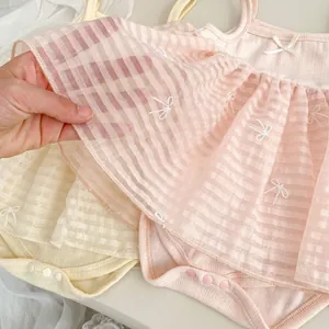 Detail of baby girl bodysuit with striped mesh skirt and delicate bow embroidery accents