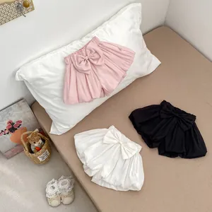 Detailed view of three girls summer bloomers with large bow decorations in three colors