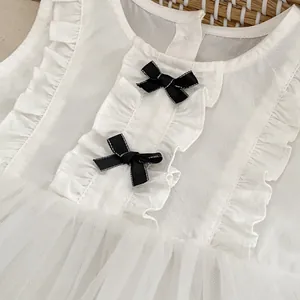 Baby girl white sleeveless mesh tulle dress with black bows and ruffle detailing