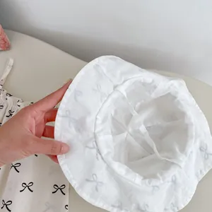 Detailed view of the internal cross-strap lining of baby bow print sun hat and set