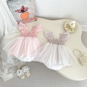 Detail of baby romper dresses featuring flutter sleeves and layered mesh tulle skirts