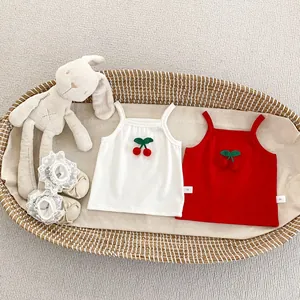 Detail of baby ribbed camisole featuring 3D cherry applique and soft cotton fabric