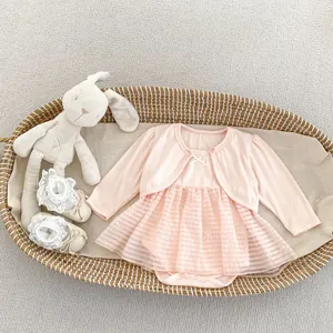 Detail of baby girl pink mesh tutu dress and cardigan set in a woven gift basket