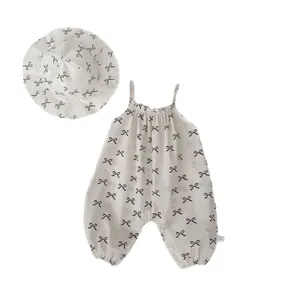 Infant cotton romper set with bow print and matching sun hat in cream white