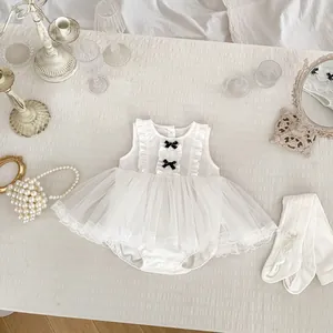 Detail view of white baby mesh tulle romper dress with cute black bows and lace edges