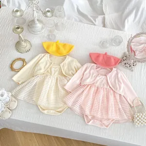 Flat lay of baby girl mesh tutu romper set with knit cardigan and matching beret hat