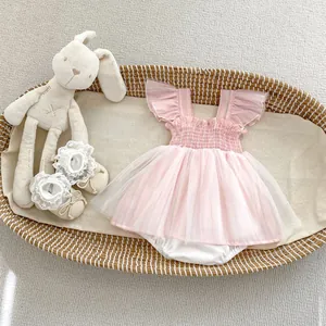 Flat lay of pink tulle baby girl romper with matching lace newborn pre-walker shoes