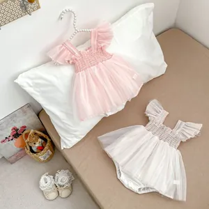 Detail of infant tulle tutu bodysuits in pink and macaron stripes with lace baby shoes
